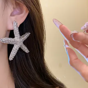Close-up of textured silver starfish earring with elegant design and steel needle