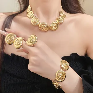 Detail view of vintage gold metal conch necklace and bracelet jewelry set on model
