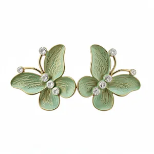 Elegant butterfly stud earrings featuring pale green enamel wings and sparkling zirconia