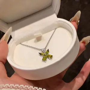 Elegant silver necklace with a green zircon flower pendant displayed in a white box