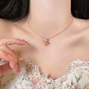 Detailed macro view of a dainty rose gold necklace featuring a sparkling zircon flower pendant.