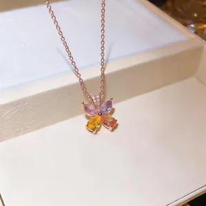 Close-up of elegant flower pendant necklace with colorful teardrop zircons.