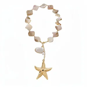 Beach-style beaded necklace featuring a textured golden starfish and seashell pendant