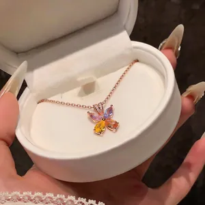 Close-up of a rose gold flower necklace with colorful teardrop zircons in a gift box