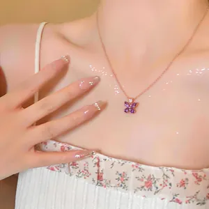 Close-up of an elegant purple zircon butterfly pendant on a dainty rose gold chain