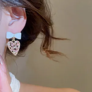 Pendientes de lazo y corazón con diamantes de imitación y aguja de plata