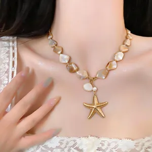Close-up of resort style shell bead necklace with golden starfish and pearl
