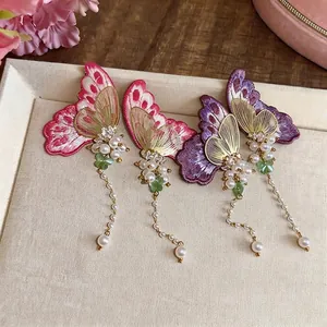 Elegant embroidered butterfly stud earrings with pearls and crystals for a sweet vacation look