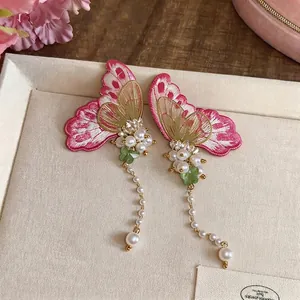 Elegant embroidered butterfly pearl earrings with long tassels for a vacation aesthetic.