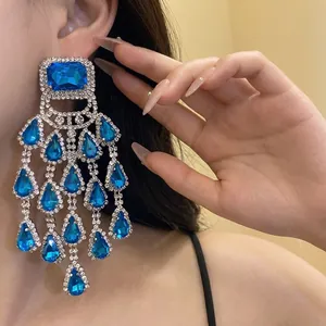 Elegant luxury blue teardrop tassel chandelier earrings with sparkling crystal detailing