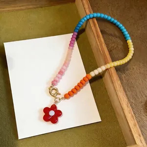 Colorful dopamine glass beaded necklace with red flower pendant for summer beach style.