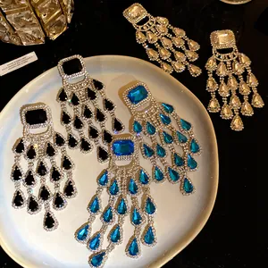 Detailed view of rhinestone chandelier earrings in black blue and clear crystal