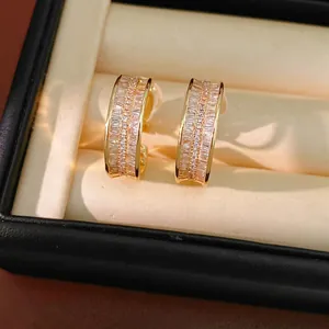 Luxury gold-plated hoop clip-on earrings encrusted with sparkling crystals in a box.