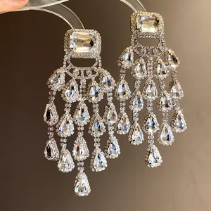Close-up view of luxury waterdrop tassel earrings with shimmering clear rhinestones
