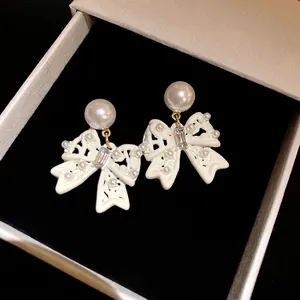 Elegant white bow earrings with pearls and crystals in a premium gift box