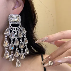 Detailed shot of elegant silver needle rhinestone chandelier earrings with teardrop tassels