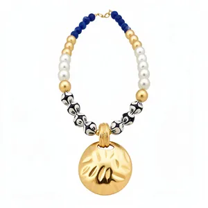 Vintage beaded necklace with pearls, ceramic beads, and hammered gold pendant