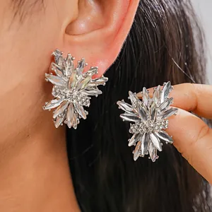 Close-up of irregular firework-shaped earrings with sparkling clear rhinestones