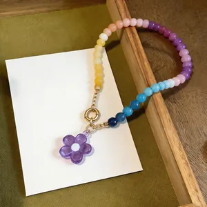 Detailed view of a colorful dopamine glass beaded necklace with a purple flower pendant.