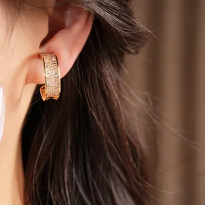 Close-up of elegant gold-plated hoop ear clip featuring baguette cubic zirconia