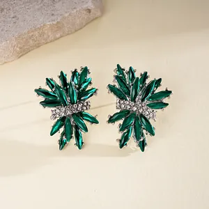 Detailed view of green firework rhinestone stud earrings with sparkling silver accents