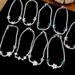 Elegant zircon butterfly and flower bracelets with sparkling crystals on black background.