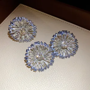 Vista detallada de anillos de flores de metal pintado con un brillante diamante de imitación