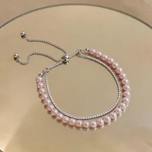 Detailed view of double-layer pink pearl and zircon bracelet with adjustable closure.
