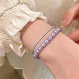 Close-up of lavender pearl and sparkling zircon double-layer bracelet on wrist