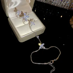 Close-up of elegant silver zircon flower integrated ring bracelet hand chain for women