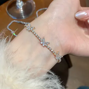 Close-up of elegant zircon butterfly bracelet on wrist with fuzzy sleeve details