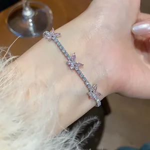 Close-up of sparkling pink zircon butterfly bracelet on a wrist, elegant jewelry detail