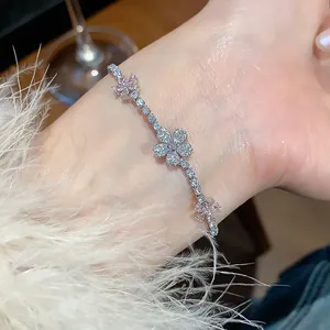 Close-up of elegant cherry blossom bracelet with pink zircons on wrist