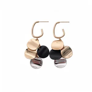 Professional studio shot of gold-plated geometric drop earrings with multicolor metallic sequins