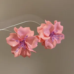Detailed view of pink 3D acrylic flower earrings featuring purple beaded centers for women