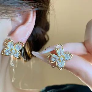 Close-up of elegant 18k gold plated flower stud earrings with zirconia and pearls