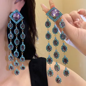 Detail showing long vintage tassel earrings with purple zircon and blue rhinestones