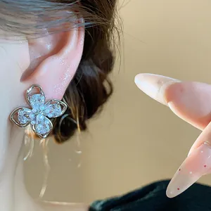Detailed view of elegant 18k gold plated flower stud earring with zircons and pearls