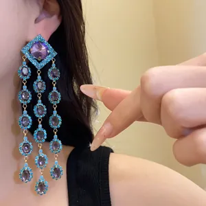 Detail showing vintage zirconia diamond-shaped tassel earrings with purple and blue stones