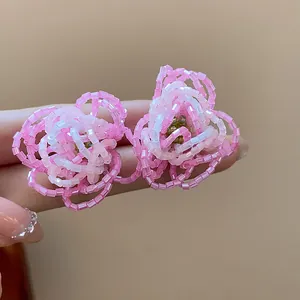 Exquisite close-up of pink handmade glass beaded flower earrings showcasing delicate texture