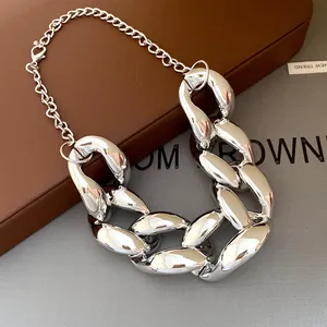 Close-up detail of a silver-toned chunky hip-hop chain necklace with shiny finish