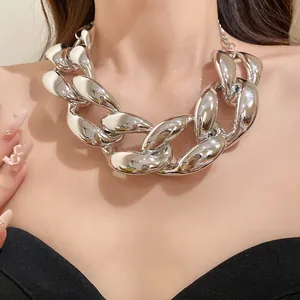 Close-up of a chunky silver-colored chain necklace in a bold punk hip-hop style.