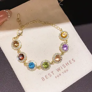 Elegant gold chain bracelet with vibrant colorful round zircons in halo settings