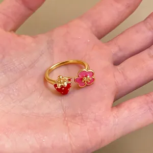 Adjustable gold-plated ring featuring cute red strawberry and pink flower charms
