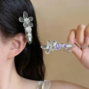 Detailed close-up of elegant acrylic flower hair clips with pearls and rhinestones