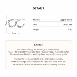 Detailed specs of silver C-shaped hoop earrings with pink heart zircons and 925 needle