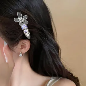 Macro detail of an elegant acrylic flower hair clip with pearls and rhinestones on hair