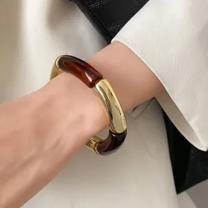 Stylish amber acrylic and gold segmented bracelet in modern Maillard aesthetic design