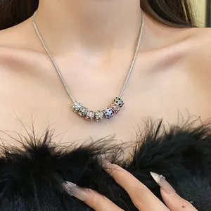 Close-up of Bohemian necklace with seven colorful crystal beads on a silver snake chain
