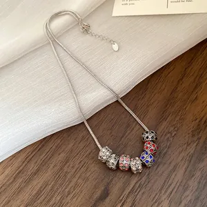 Close-up of bohemian silver snake chain necklace with vibrant rhinestone beads